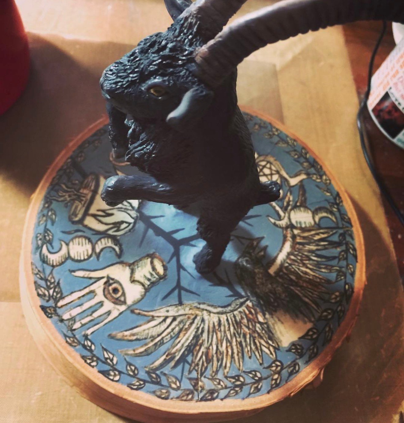 Black Phillip goat sculpture on blue folk art base by Loren Morris, Primitive Witchery